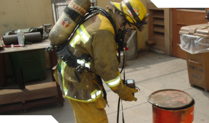 Los Angeles Fire Department firefighter inspects red barrel