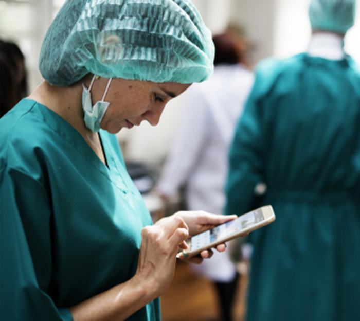 Medical professional looking a mobile device