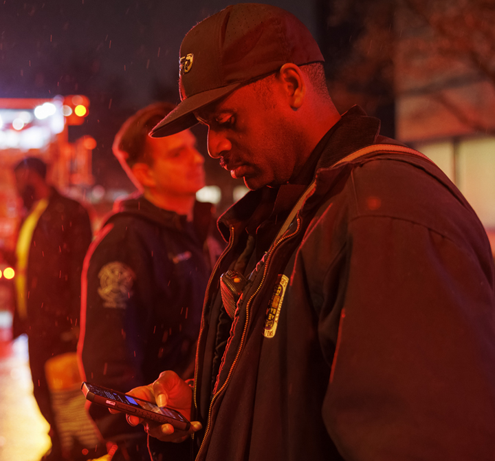 A member of the Douglas County Sheriff department checks his phone while participating in a car stop in Douglas County Nebraska.