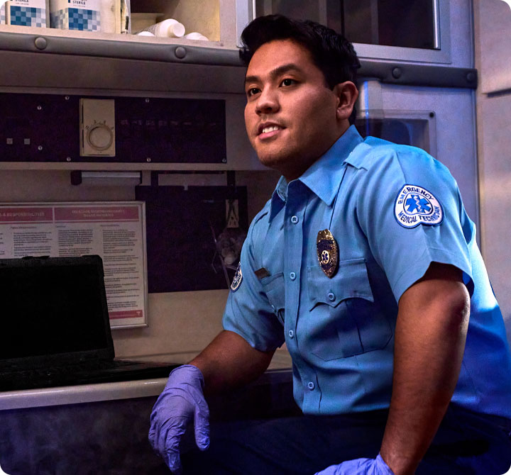 Hisplanic EMS first responder sitting inside ambulance 