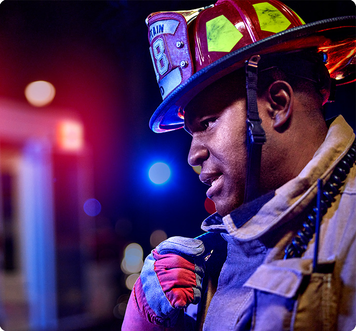 Firefigher using firstnet push-to-talk device on scene