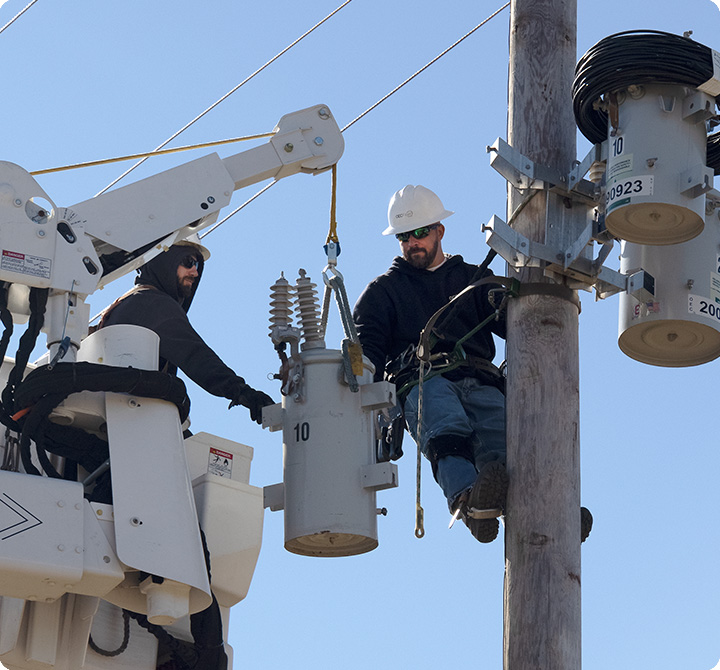 Two men in a utilities bucket fixing electricity connectivity 