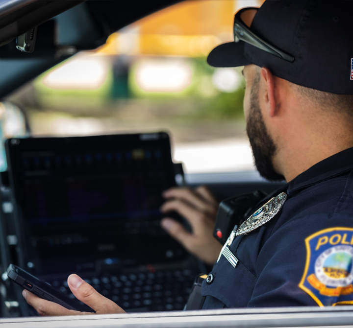 Officer using laptop in vehicle