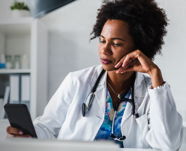 Medical professional looking at tablet in office