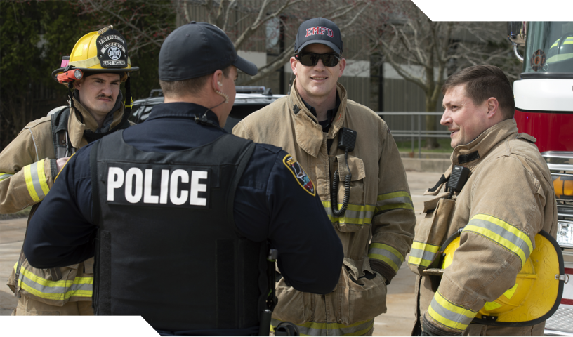 Group of firefighters talking to police officer