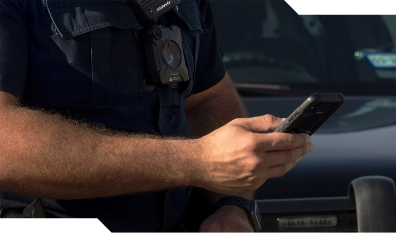 Police officer looking at mobile phone